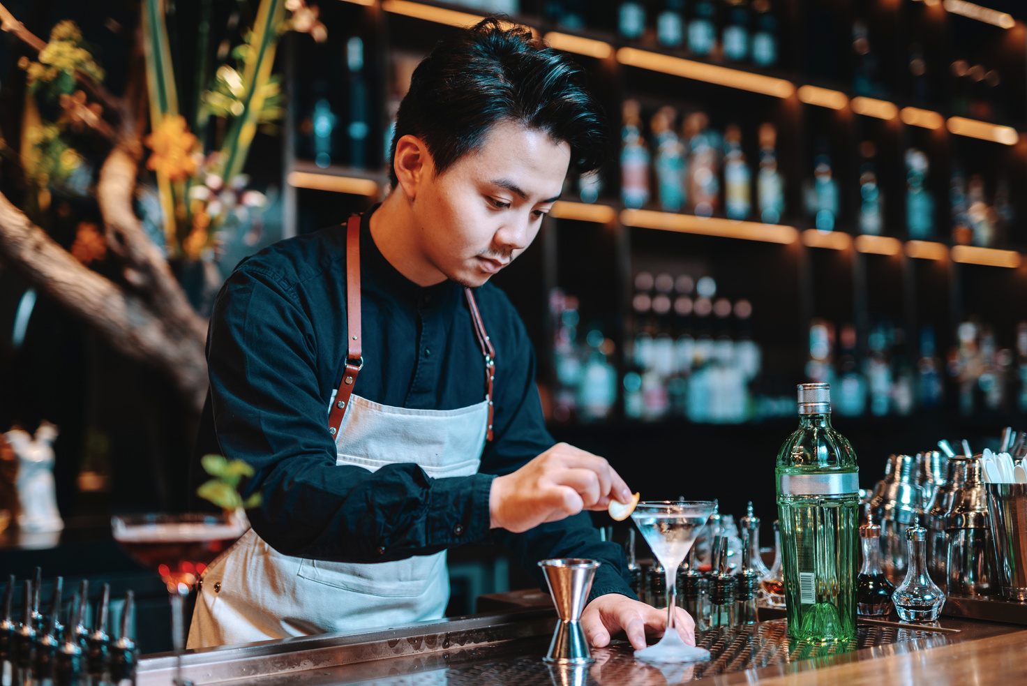 Chinese bar tender and cocktail master behind the counter